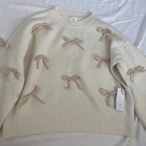 New Luna Ivy (anthropologie) creme sweater with tan bows Size: Small.